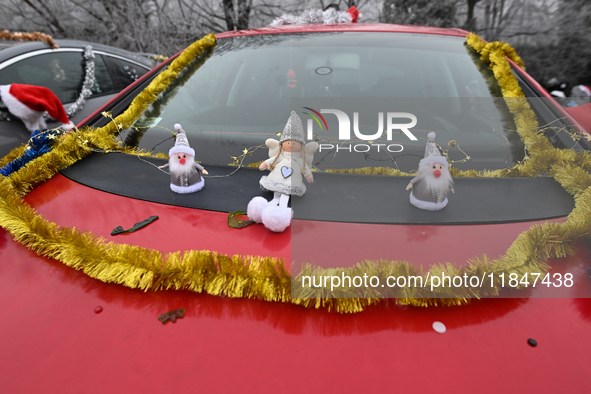 KRAKOW, POLAND - DECEMBER 08: Christmas decorations seen of cars parked outside the Pediatric Hospital in Krakow as Santa Clauses deliver Ch...