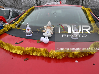 KRAKOW, POLAND - DECEMBER 08: Christmas decorations seen of cars parked outside the Pediatric Hospital in Krakow as Santa Clauses deliver Ch...