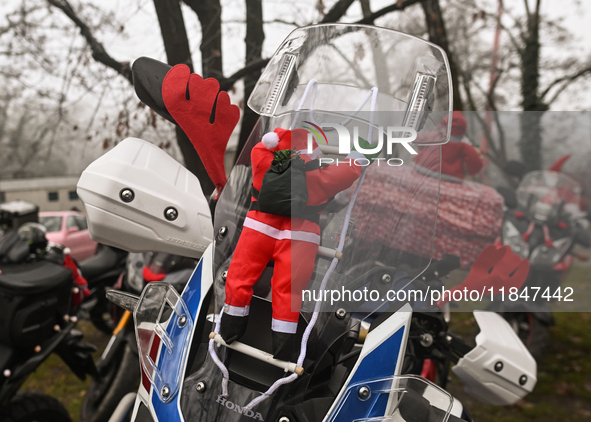 KRAKOW, POLAND - DECEMBER 08: Christmas decorations seen of motorcycles parked outside the Pediatric Hospital in Krakow as Santa Clauses del...