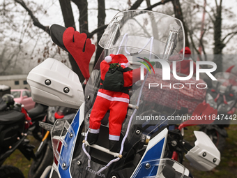 KRAKOW, POLAND - DECEMBER 08: Christmas decorations seen of motorcycles parked outside the Pediatric Hospital in Krakow as Santa Clauses del...