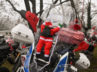 KRAKOW, POLAND - DECEMBER 08: Christmas decorations seen of motorcycles parked outside the Pediatric Hospital in Krakow as Santa Clauses del...