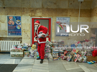 KRAKOW, POLAND - DECEMBER 08: A Santa poses for a photo with Christmas Gifts at the entrance to the Pediatric Hospital in Krakow, as hundred...