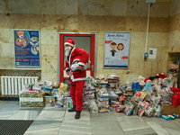 KRAKOW, POLAND - DECEMBER 08: A Santa poses for a photo with Christmas Gifts at the entrance to the Pediatric Hospital in Krakow, as hundred...