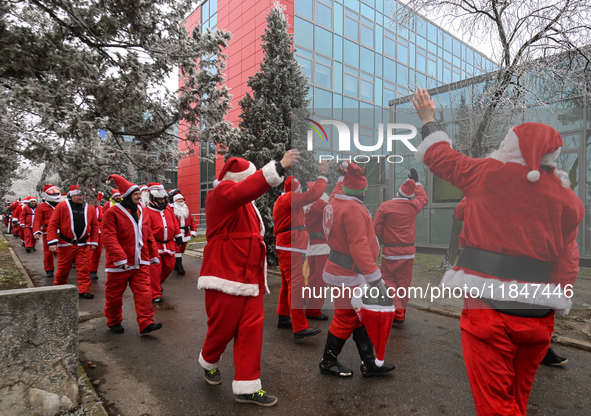 KRAKOW, POLAND - DECEMBER 08: Hundreds of motorcycle riders dressed as Santa Claus circle the Pediatric Hospital, shouting 'Ho Ho Ho' and wa...