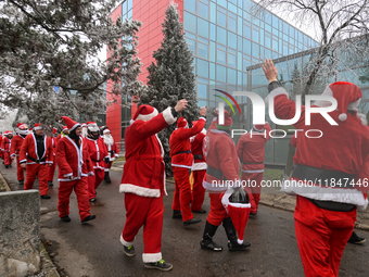 KRAKOW, POLAND - DECEMBER 08: Hundreds of motorcycle riders dressed as Santa Claus circle the Pediatric Hospital, shouting 'Ho Ho Ho' and wa...