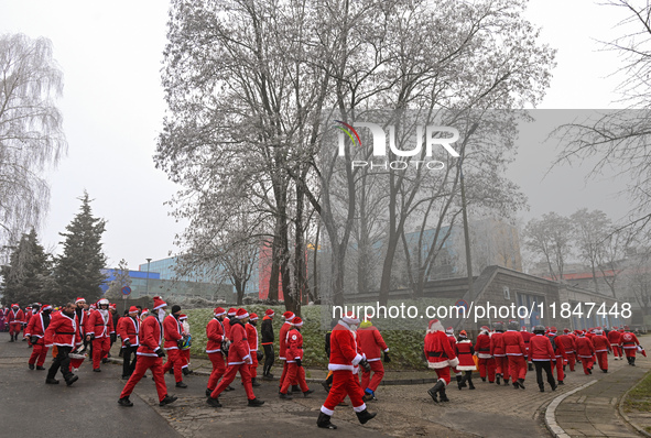 KRAKOW, POLAND - DECEMBER 08: Hundreds of motorcycle riders dressed as Santa Claus circle the Pediatric Hospital, shouting 'Ho Ho Ho' and wa...