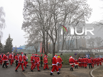 KRAKOW, POLAND - DECEMBER 08: Hundreds of motorcycle riders dressed as Santa Claus circle the Pediatric Hospital, shouting 'Ho Ho Ho' and wa...