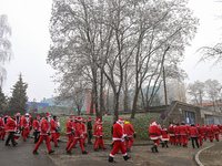 KRAKOW, POLAND - DECEMBER 08: Hundreds of motorcycle riders dressed as Santa Claus circle the Pediatric Hospital, shouting 'Ho Ho Ho' and wa...