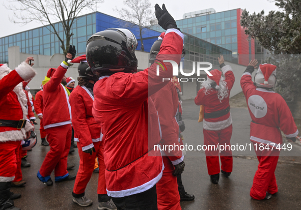 KRAKOW, POLAND - DECEMBER 08: Hundreds of motorcycle riders dressed as Santa Claus circle the Pediatric Hospital, shouting 'Ho Ho Ho' and wa...