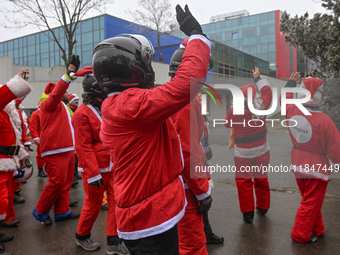 KRAKOW, POLAND - DECEMBER 08: Hundreds of motorcycle riders dressed as Santa Claus circle the Pediatric Hospital, shouting 'Ho Ho Ho' and wa...