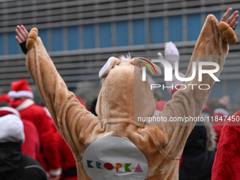 KRAKOW, POLAND - DECEMBER 08: Hundreds of motorcycle riders dressed as Santa Claus circle the Pediatric Hospital, shouting 'Ho Ho Ho' and wa...