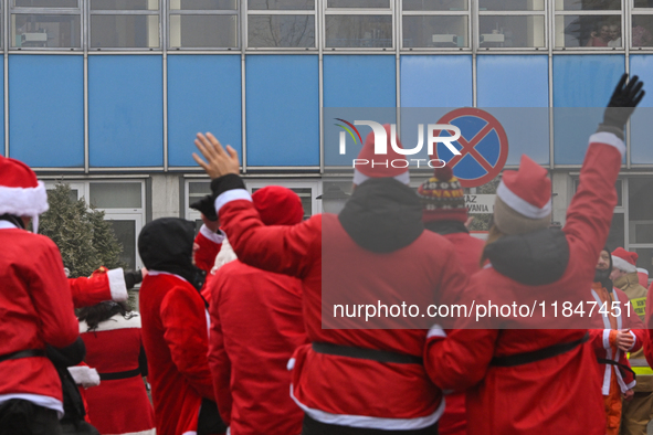 KRAKOW, POLAND - DECEMBER 08: Hundreds of motorcycle riders dressed as Santa Claus circle the Pediatric Hospital, shouting 'Ho Ho Ho' and wa...