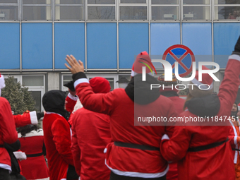 KRAKOW, POLAND - DECEMBER 08: Hundreds of motorcycle riders dressed as Santa Claus circle the Pediatric Hospital, shouting 'Ho Ho Ho' and wa...