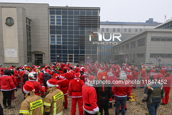 KRAKOW, POLAND - DECEMBER 08: Hundreds of motorcycle riders dressed as Santa Claus circle the Pediatric Hospital, shouting 'Ho Ho Ho' and wa...