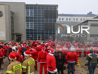 KRAKOW, POLAND - DECEMBER 08: Hundreds of motorcycle riders dressed as Santa Claus circle the Pediatric Hospital, shouting 'Ho Ho Ho' and wa...