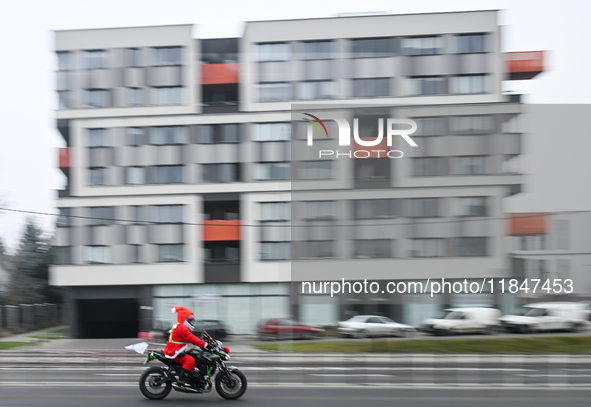 KRAKOW, POLAND - DECEMBER 08: 
A motorcycle rider dressed as Santa Claus seen after delivering Christmas gifts to young patients at the Pedi...