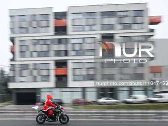 KRAKOW, POLAND - DECEMBER 08: 
A motorcycle rider dressed as Santa Claus seen after delivering Christmas gifts to young patients at the Pedi...