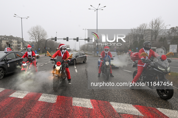 KRAKOW, POLAND - DECEMBER 08: Motorcycle riders dressed as Santa Claus depart after delivering Christmas gifts to young patients at the Pedi...