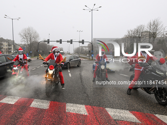 KRAKOW, POLAND - DECEMBER 08: Motorcycle riders dressed as Santa Claus depart after delivering Christmas gifts to young patients at the Pedi...