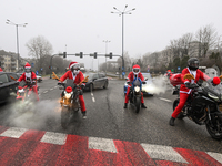 KRAKOW, POLAND - DECEMBER 08: Motorcycle riders dressed as Santa Claus depart after delivering Christmas gifts to young patients at the Pedi...