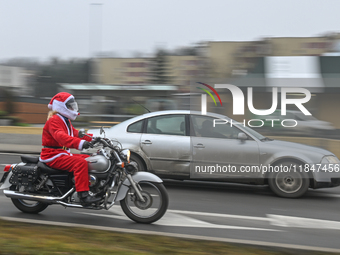 KRAKOW, POLAND - DECEMBER 08: 
A motorcycle rider dressed as Santa Claus seen after delivering Christmas gifts to young patients at the Pedi...