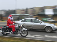 KRAKOW, POLAND - DECEMBER 08: 
A motorcycle rider dressed as Santa Claus seen after delivering Christmas gifts to young patients at the Pedi...