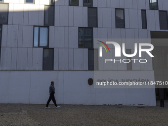 In Lisbon, Portugal, on December 8, 2024, people walk by the Judiciary Police Headquarters. The Judiciary Police (PJ) carry out a major oper...