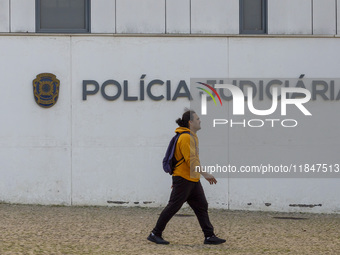 In Lisbon, Portugal, on December 8, 2024, people walk by the Judiciary Police Headquarters. The Judiciary Police (PJ) carry out a major oper...