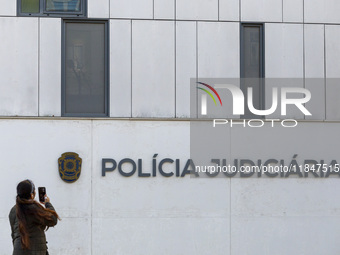 In Lisbon, Portugal, on December 8, 2024, people walk by the Judiciary Police Headquarters. The Judiciary Police (PJ) carry out a major oper...