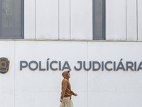 In Lisbon, Portugal, on December 8, 2024, people walk by the Judiciary Police Headquarters. The Judiciary Police (PJ) carry out a major oper...