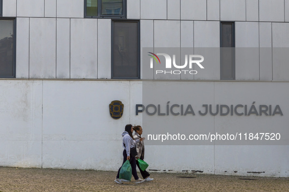 In Lisbon, Portugal, on December 8, 2024, people walk by the Judiciary Police Headquarters. The Judiciary Police (PJ) carry out a major oper...