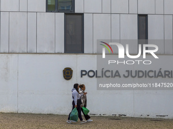 In Lisbon, Portugal, on December 8, 2024, people walk by the Judiciary Police Headquarters. The Judiciary Police (PJ) carry out a major oper...