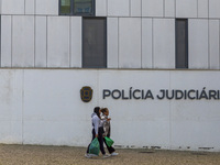 In Lisbon, Portugal, on December 8, 2024, people walk by the Judiciary Police Headquarters. The Judiciary Police (PJ) carry out a major oper...