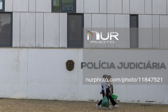 In Lisbon, Portugal, on December 8, 2024, people walk by the Judiciary Police Headquarters. The Judiciary Police (PJ) carry out a major oper...