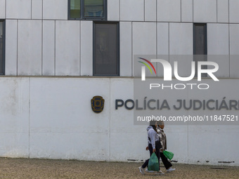 In Lisbon, Portugal, on December 8, 2024, people walk by the Judiciary Police Headquarters. The Judiciary Police (PJ) carry out a major oper...