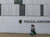 In Lisbon, Portugal, on December 8, 2024, people walk by the Judiciary Police Headquarters. The Judiciary Police (PJ) carry out a major oper...