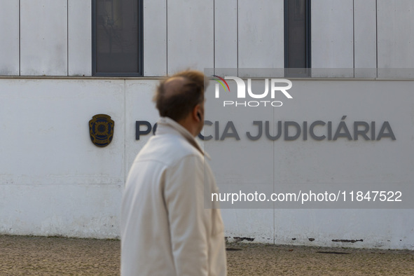 A person walks by the Judiciary Police Headquarters in Lisbon, Portugal, on December 8, 2024. The Judiciary Police (PJ) carry out a major op...