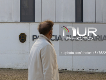 A person walks by the Judiciary Police Headquarters in Lisbon, Portugal, on December 8, 2024. The Judiciary Police (PJ) carry out a major op...