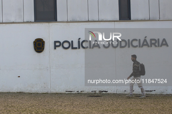 A person walks by the Judiciary Police Headquarters in Lisbon, Portugal, on December 8, 2024. The Judiciary Police (PJ) carry out a major op...