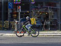 A food delivery person rides a bike in Lisbon, Portugal, on December 8, 2024. Glovo, the app-based food delivery service, hires its freelanc...