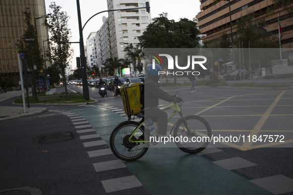 A food delivery person rides a bike in Lisbon, Portugal, on December 8, 2024. Glovo, the app-based food delivery service, hires its freelanc...