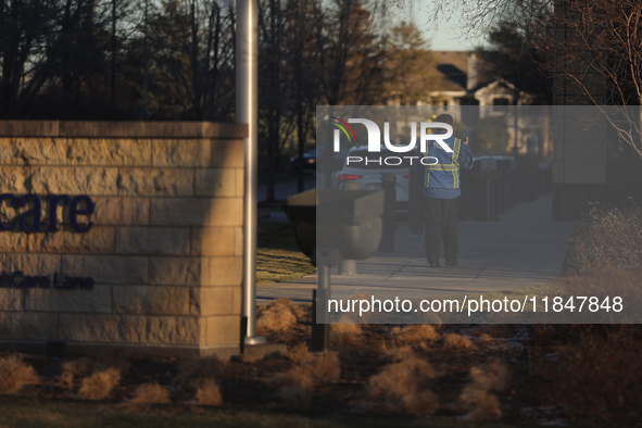 A security guard walks towards the front of the UnitedHealthcare corporate headquarters in Minnetonka, on December 5, 2024. Increased securi...