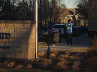 A security guard walks towards the front of the UnitedHealthcare corporate headquarters in Minnetonka, on December 5, 2024. Increased securi...