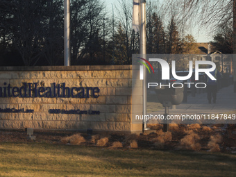 A security guard walks towards the front of the UnitedHealthcare corporate headquarters in Minnetonka, on December 5, 2024. Increased securi...