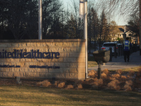 A security guard walks towards the front of the UnitedHealthcare corporate headquarters in Minnetonka, on December 5, 2024. Increased securi...