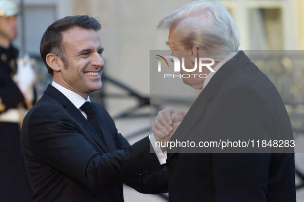 France's President Emmanuel Macron welcomes the United States President-elect Donald Trump before the bilateral talks in Paris, France, on D...