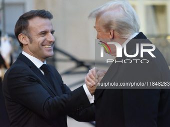 France's President Emmanuel Macron welcomes the United States President-elect Donald Trump before the bilateral talks in Paris, France, on D...