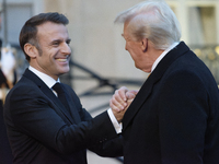 France's President Emmanuel Macron welcomes the United States President-elect Donald Trump before the bilateral talks in Paris, France, on D...