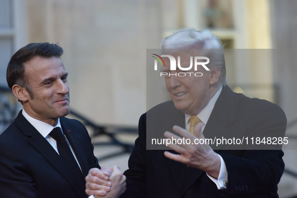 France's President Emmanuel Macron welcomes the United States President-elect Donald Trump before the bilateral talks in Paris, France, on D...