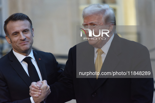 France's President Emmanuel Macron welcomes the United States President-elect Donald Trump before the bilateral talks in Paris, France, on D...